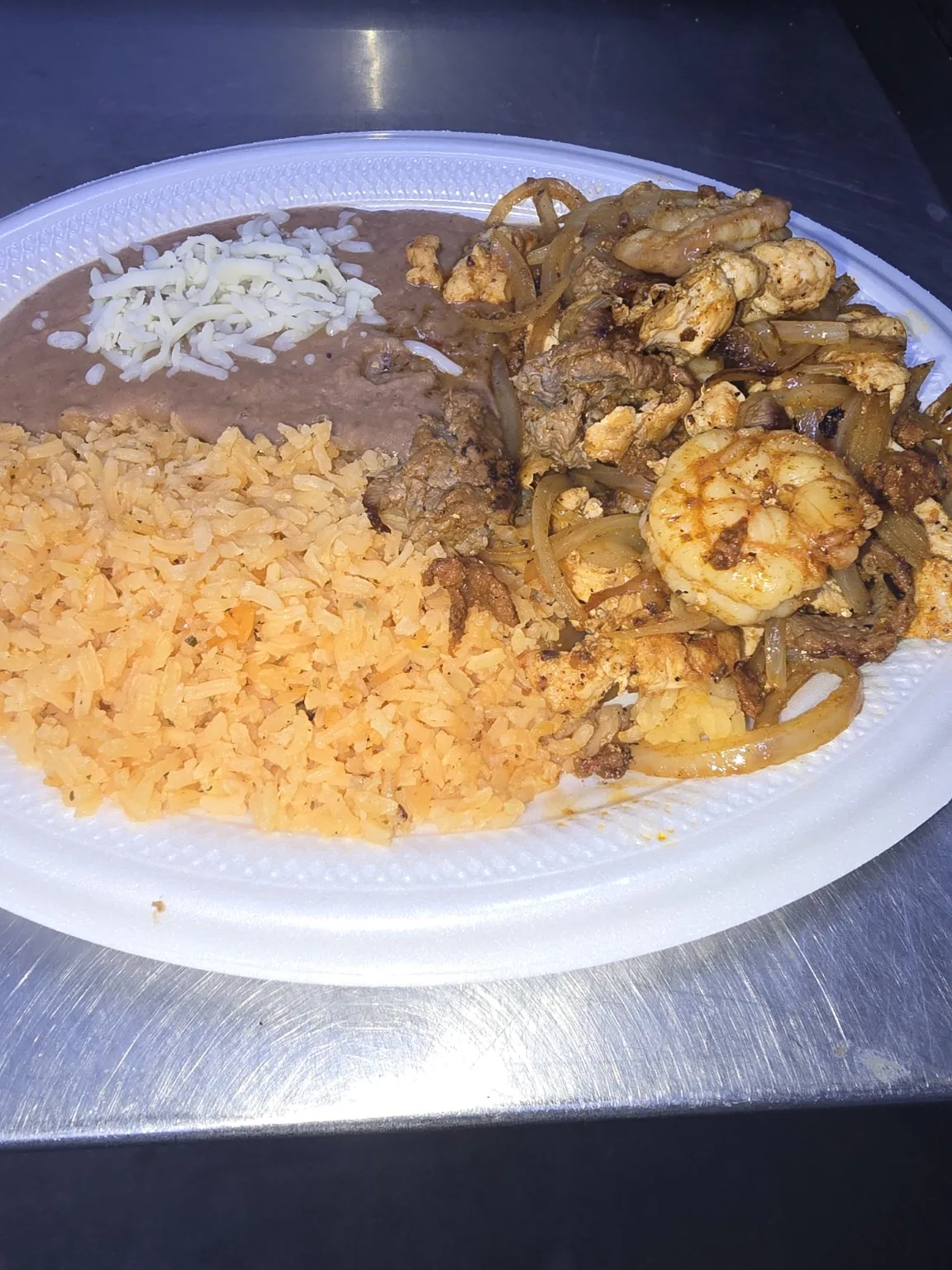 House fajita with grilled meats, rice and beans at Armored Tacos & Grill